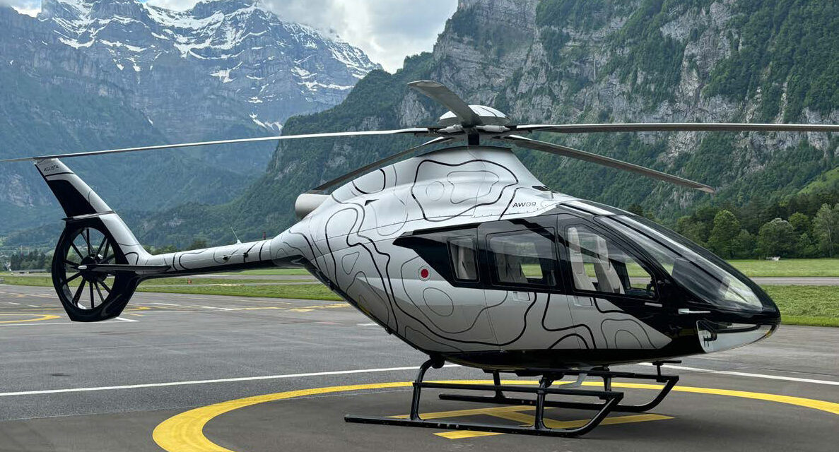 Leonardo AW09 helicopter parked on a mountain airfield.